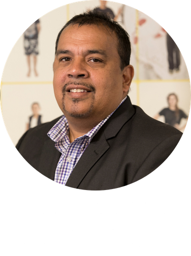 Portrait of James Atkinson in a dark suit and checkered shirt, with his name and titles shown below.